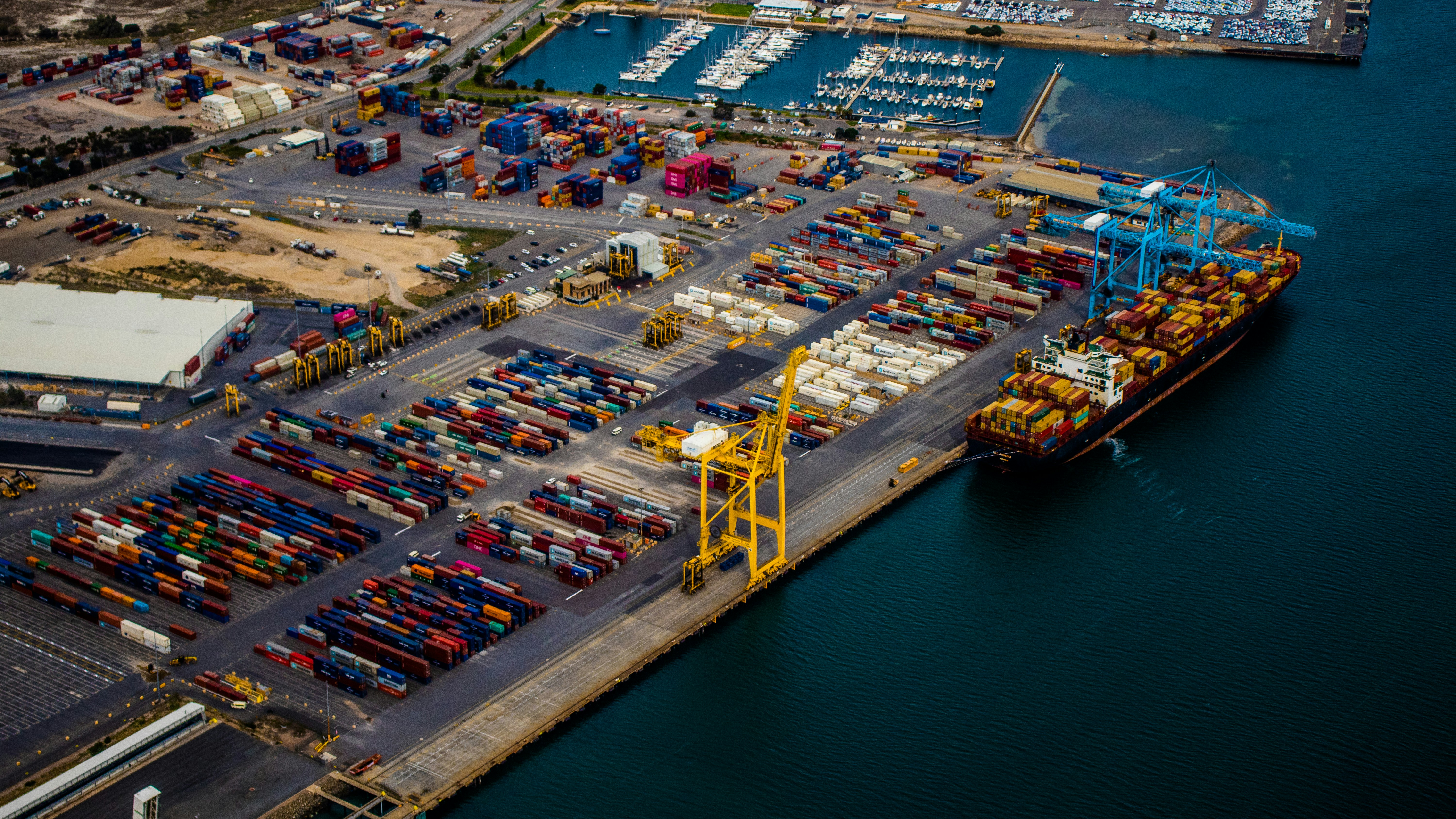 Cover image for the post. A docked shipping ship full of shipping containers on a body of water. Photo taken by Alex Duffy.