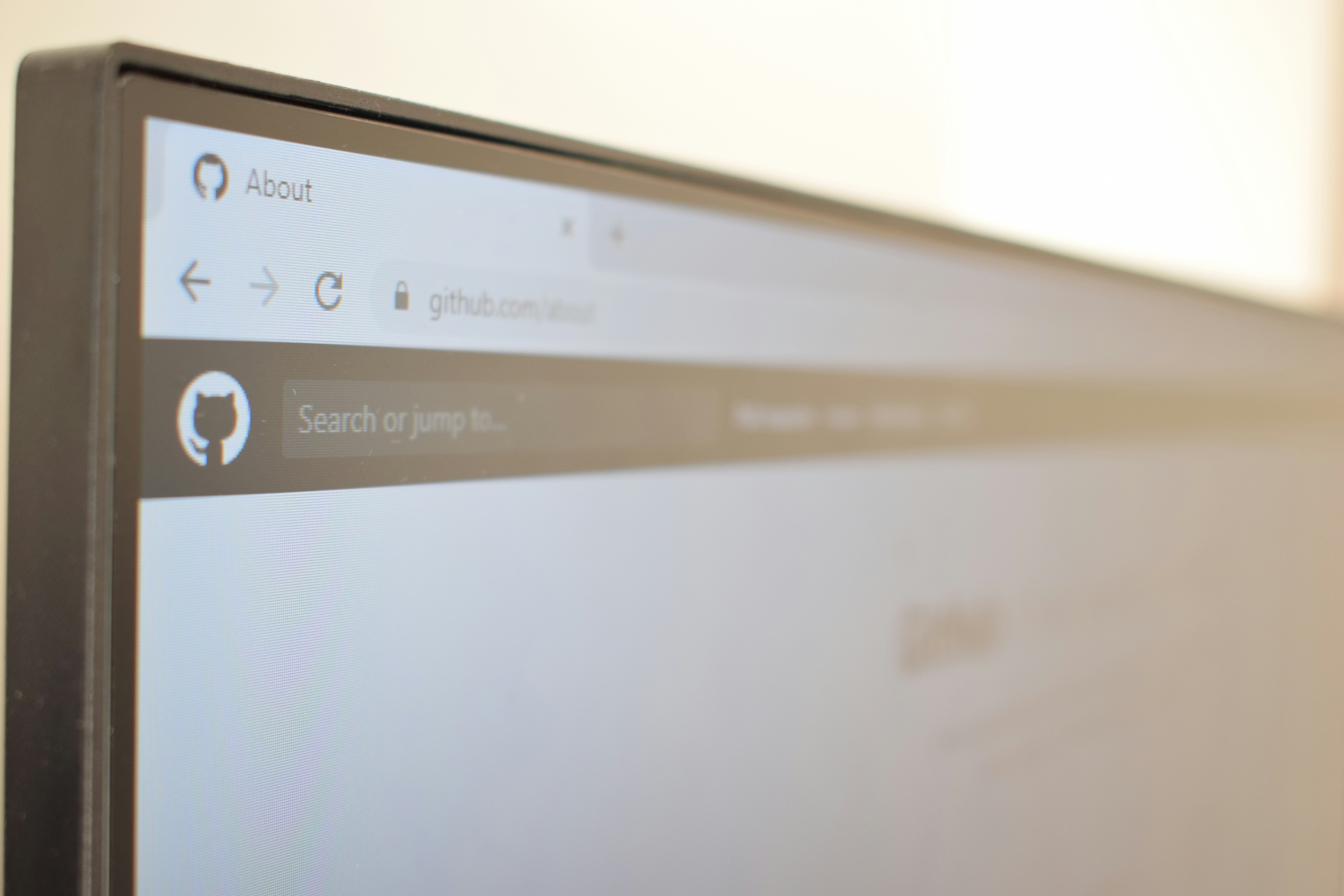 Cover image for the post. Computer monitor showing the GitHub About page. Photo taken by Richy Great.