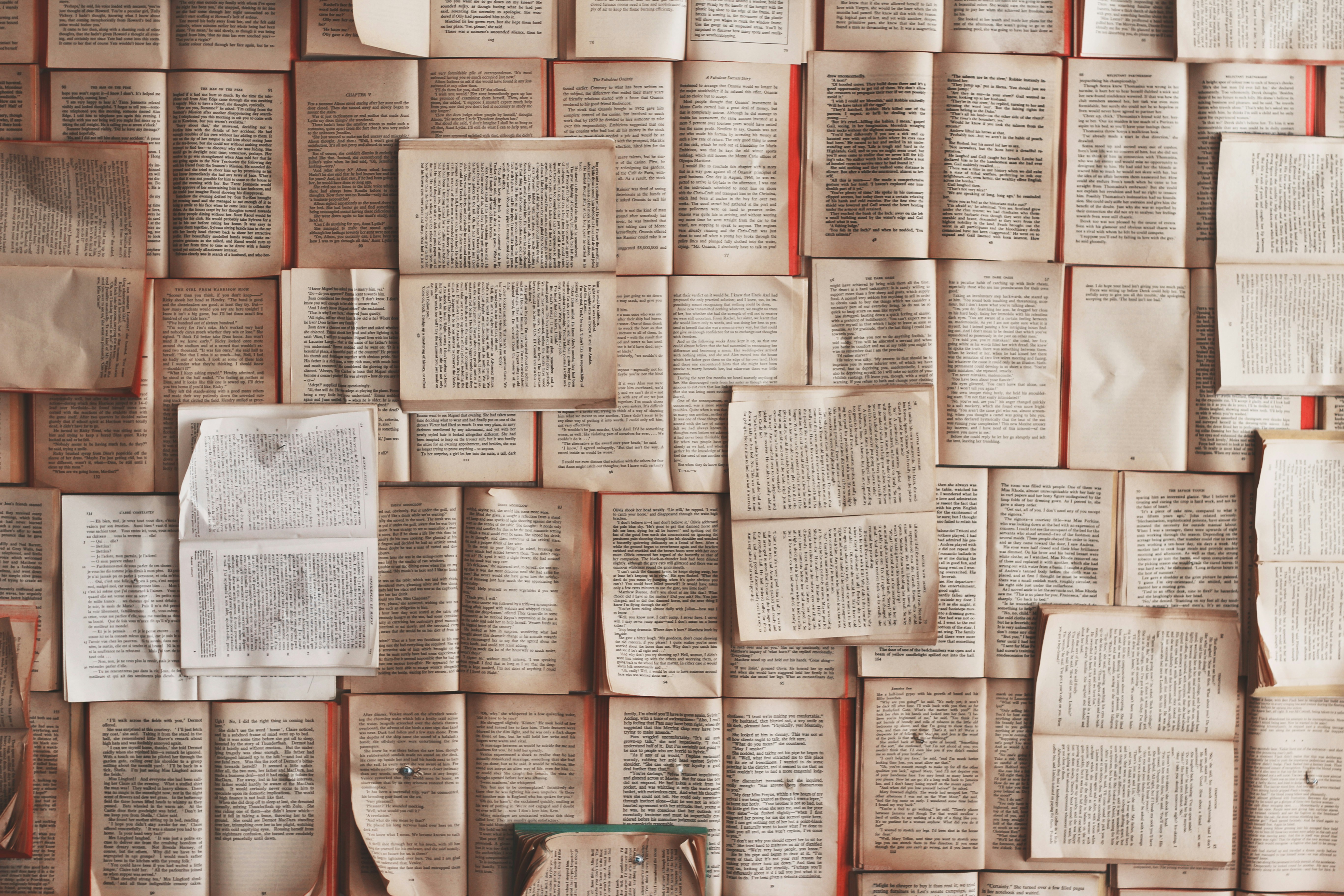 Cover image for the post. Several books open with yellow pages and black text. Photo taken by Patrick Tomasso.